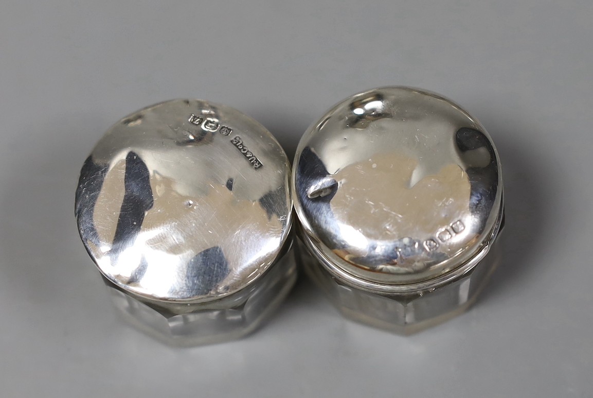 An Edwardian silver two handled posy vase, 13.7cm, a silver mounted glass scent bottle and three similar toilet jars.